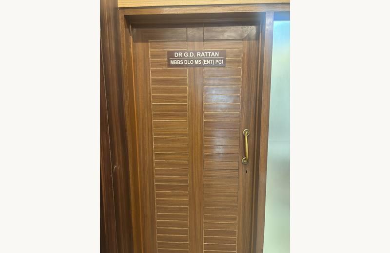 Clinic main entrance with handcrafted teak consultation chamber doors
